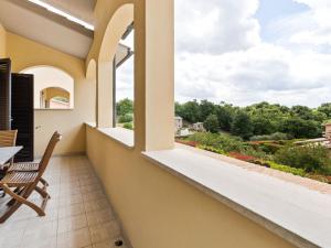 a balcony with a table and chairs and a view at Elegant Holiday Home in Sorano with Swimming Pool in Sorano