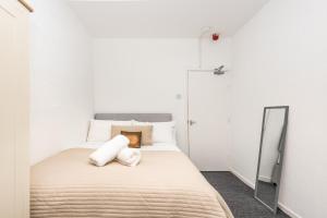 um quarto com uma cama grande e um espelho em Velvet Coaster Apartments em Blackpool