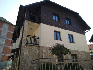 a house with a black and white at Apartman SIX Zlatibor in Zlatibor