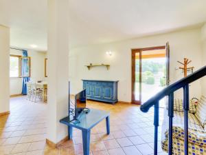 a living room with a staircase and a table at Pleasing Holiday Home in Sorano with Swimming Pool in Sorano