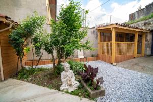 a statue of a buddha in front of a house at etape gimontoise 32 "Chambre tout confort" in Gimont