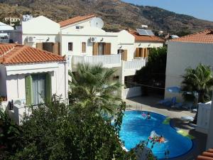 a view of a swimming pool in front of a house at Alexandra in Marathokampos