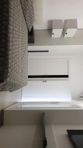 a white kitchen with a white counter top at Iris home in Metaponto