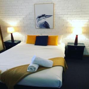 a bedroom with a bed with two towels on it at Montville Holiday Apartments in Montville +63 photos