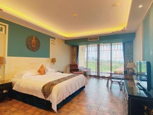 um quarto com uma cama e uma televisão num quarto em Luhuitou State Guesthouse & Resort em Sanya