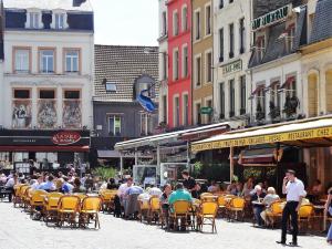 a crowd of people sitting at tables and chairs in a street at Kelys Centre T2 Confort Moderne in Boulogne-sur-Mer