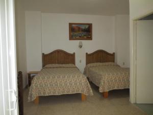 Postel nebo postele na pokoji v ubytování Hotel Posada Diamante