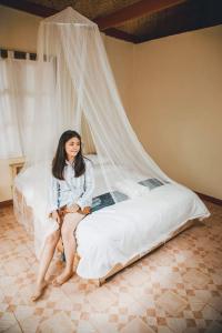 En eller flere senge i et værelse på Nongtao Homestay