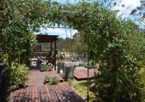 a garden with a wooden deck and a gazebo at Rosetta Homestead in The Summit
