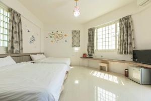 Cama o camas de una habitación en 實在玩家民宿