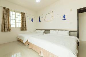 Cama o camas de una habitación en 實在玩家民宿