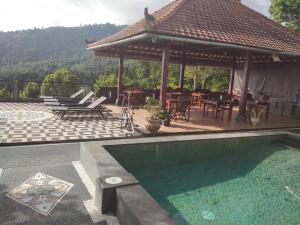 a patio with a pavilion and a swimming pool at Adila Warung and Homestay in Munduk