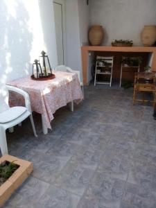 a dining room with a table and chairs and a floor at Summer Studios 2 in Koroni