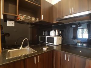 a kitchen with a sink and a microwave at xh apartment in Danang