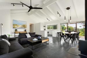 a living room with a couch and a table at 1 Oak - Rye Back Beach Accommodation in Saint Andrews Beach