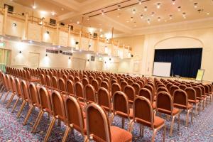 an empty lecture hall with chairs and a podium at The Angel Hotel in Cardiff