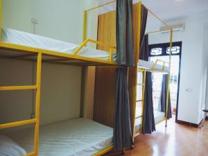 a room with two bunk beds in a room at Be's Home & Tours in Ha Giang