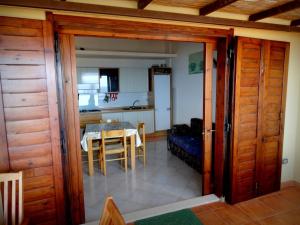 a kitchen and dining room with a table in a room at Villetta Best Vacation Ever, Costa Rei in Costa Rei