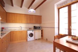 a kitchen with a washing machine and a table at Apartamento Cop City Centre by costablancarent in Denia +17 photos