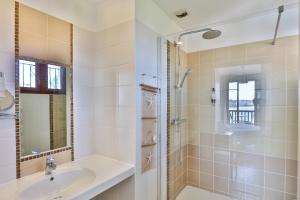 a bathroom with a sink and a shower at Hotel Agur Deneri in Ciboure