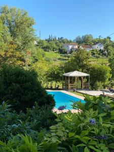 a swimming pool with a gazebo in a garden at La Giorgetta in Ovada