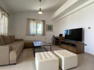 a living room with a couch and a flat screen tv at Holiday House Laura in Vir