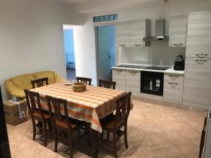 a kitchen with a table and chairs and a kitchen with a stove at B&B Giulia in Parma