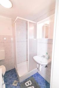皮蘭的住宿－Fri Apartment，带淋浴和盥洗盆的白色浴室