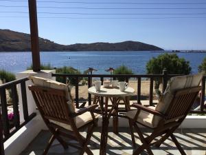 a table and chairs on a balcony with a view of the water at Asteri Hotel in Livadi