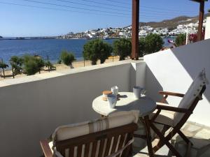 a table and chairs on a balcony with a view of the water at Asteri Hotel in Livadi