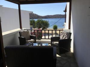 a balcony with chairs and a view of the ocean at Asteri Hotel in Livadi