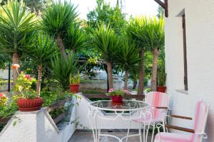A garden outside ILIOCHARI sea view apartments Oropos - Kalamos