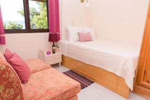 A bed or beds in a room at ILIOCHARI sea view apartments Oropos - Kalamos
