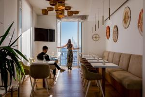 a man sitting at a table in a restaurant at Hotel Aristeo in Cagliari