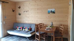 a room with a table and a couch and a table and chairs at Gästehaus am Hahnenkamm in Reutte