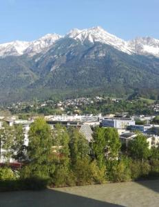 una ciudad con montañas cubiertas de nieve en el fondo en Close en Innsbruck