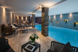 a living room with a swimming pool at Annapurna by Alpine Resorts in Les Gets
