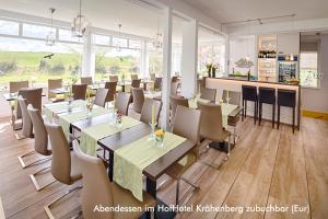 a restaurant with tables and chairs in a room at Ferienwohnung Feldblick in Grömitz