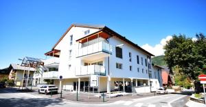 a white building with cars parked in front of it at Haus Konny in Schladming