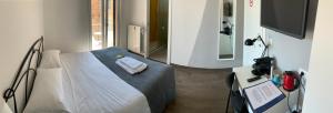 a bedroom with a bed with a mirror and a camera at Mambo Suites in Bologna