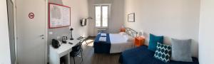 a bedroom with a bed and a sink and a couch at Mambo Suites in Bologna