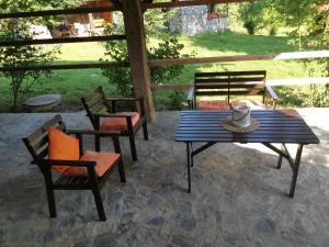 a patio with a table and chairs on a patio at Vetrovi šumijo I in Kapele