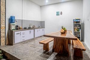 a kitchen with a wooden table in a room at Private Room Kayu Bunga in Canggu