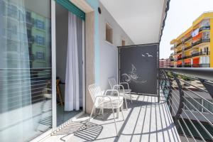a balcony with two chairs and a table on it at San Francisco rooms in Marina di Andora
