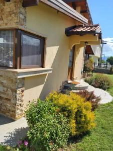 a house with some plants in front of it at Apartments and Villas Janev in Star Dojran