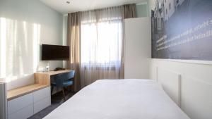 Säng eller sängar i ett rum på Hotel Huss Limburg