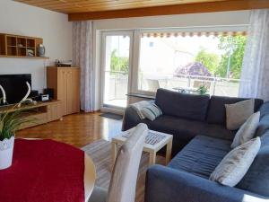 a living room with a couch and a table at Ferienwohnung Groß in Blaubeuren