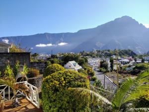 Vue sur une ville avec une montagne en arrière-plan dans l'établissement CÔTE MONTAGNE, à Cilaos