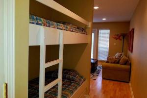 a bedroom with a bunk bed in a room at Grand Caribbean in Pensacola