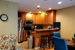 a kitchen with wooden cabinets and a counter top at Grand Caribbean in Pensacola